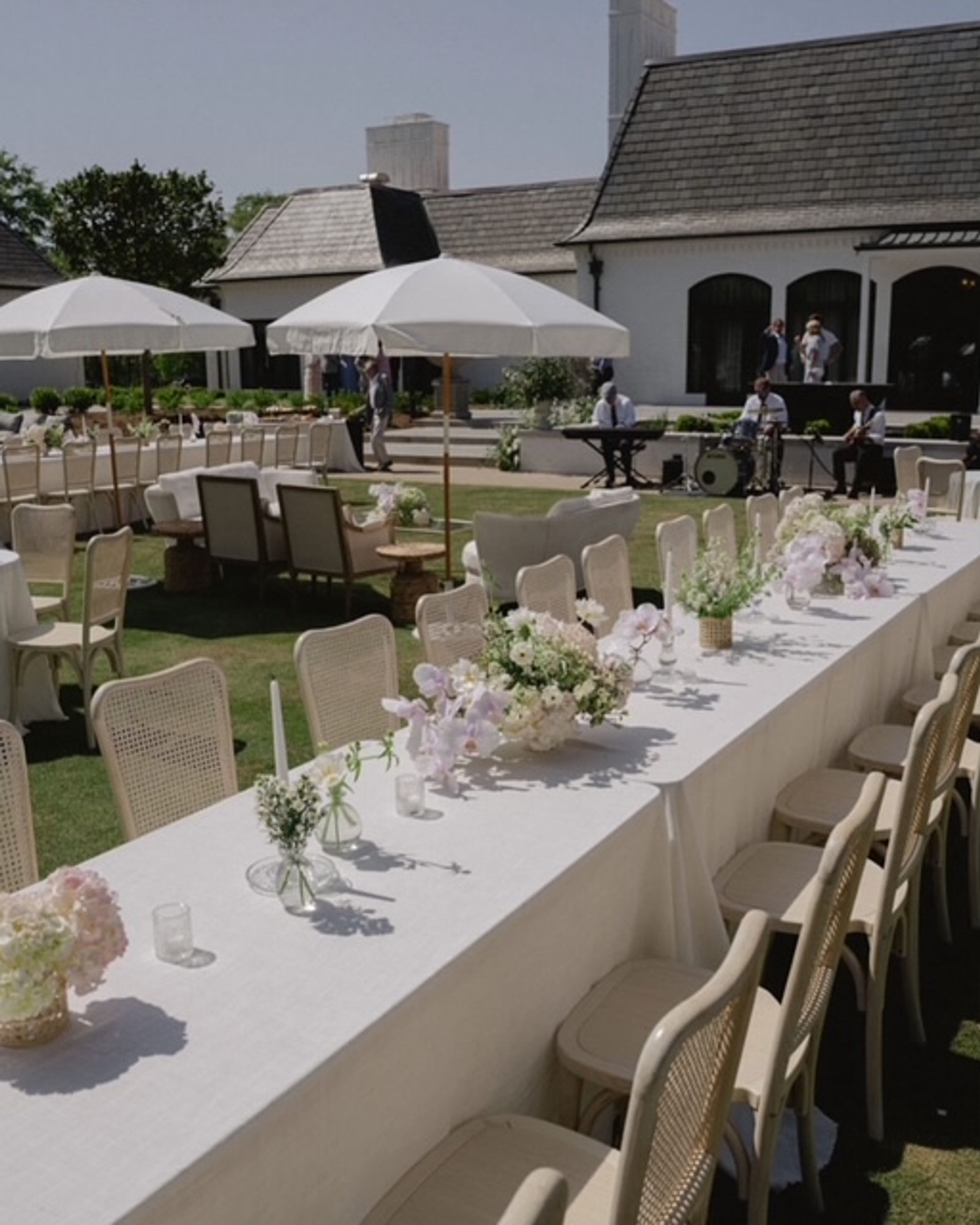 Outdoor luxury wedding reception with long banquet tables